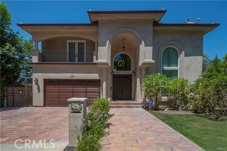 Situated south of the Boulevard in the heart of Studio City, this contemporary Tuscan villa blends timeless elegance with custom craftsmanship. The grand entry opens to a dramatic living room with soaring 30-foot ceilings and an effortless, open flow, perfect for entertaining. A chef’s kitchen, outfitted with Viking appliances and a center island, seamlessly connects to the formal dining room. The spacious family room opens to an expansive balcony with serene mountain views, overlooking the resort-style pool and spa. A sweeping staircase leads to the luxurious primary suite, featuring a spa-like bath with steam shower and soaking tub, plus a show stopping walk-in closet. The top floor offers two additional bedroom suites, each with its own private bath. This exceptional property also includes guest quarters or a private office with its own entrance, complete with a living room, full kitchen, large bedroom and bath, laundry room, and a generous patio overlooking the pool. All just moments from the shops and restaurants along Ventura Boulevard.
