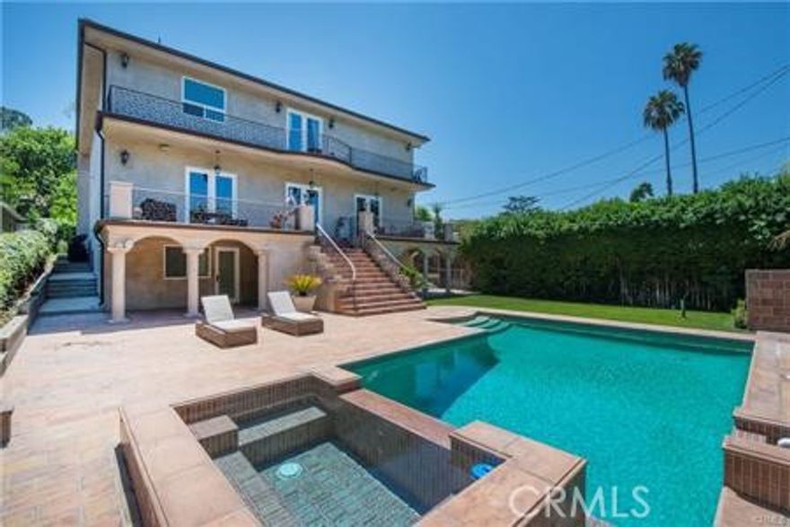 Situated south of the Boulevard in the heart of Studio City, this contemporary Tuscan villa blends timeless elegance with custom craftsmanship. The grand entry opens to a dramatic living room with soaring 30-foot ceilings and an effortless, open flow, perfect for entertaining. A chef’s kitchen, outfitted with Viking appliances and a center island, seamlessly connects to the formal dining room. The spacious family room opens to an expansive balcony with serene mountain views, overlooking the resort-style pool and spa. A sweeping staircase leads to the luxurious primary suite, featuring a spa-like bath with steam shower and soaking tub, plus a show stopping walk-in closet. The top floor offers two additional bedroom suites, each with its own private bath. This exceptional property also includes guest quarters or a private office with its own entrance, complete with a living room, full kitchen, large bedroom and bath, laundry room, and a generous patio overlooking the pool. All just moments from the shops and restaurants along Ventura Boulevard.