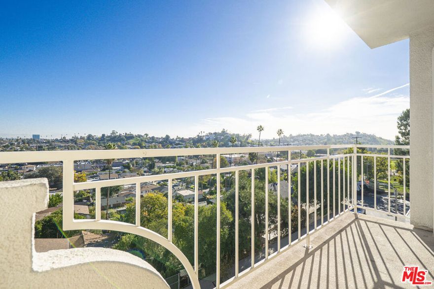 Nestled in the hills of El Sereno, this private gated community offers a serene, resort-style lifestyle with an array of desirable amenities. Unit #2210 welcomes you with a spacious front patio and an inviting entry that offers an immediate glimpse of the home's standout feature, expansive sliding glass doors spanning nearly the entire east-facing wall. These doors bathe the interior in natural light while showcasing sweeping city views framed by treetops. The lower level features a front bedroom with sliding glass doors that open directly to the patio, along with a conveniently located full bathroom and an in-unit stackable washer and dryer. The primary suite offers a generous walk-in closet, while the upper-level suite includes its own private entrance and full bath, making it ideal for guests, extended family, or potential rental use. Hilltop Colony is a dog-friendly community with beautifully maintained grounds and resort-style amenities, including a pool and spa, playground, barbecue area, and a recreation room with a full kitchen perfect for entertaining and gatherings.