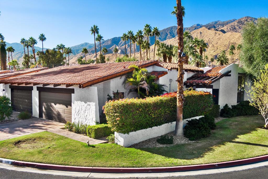 Discover the allure of this rare, updated end single family attached home with an abundance of natural light and captivating mountain views. Designed by famed architect Barry Berkus, this home has undergone a meticulous remodeling, featuring porcelain tile floors that flow seamlessly throughout the entire space. As you step through the double doors, you'll be greeted by an expansive, open layout complemented with high beamed ceilings and walls of glass. Perfect for entertaining, the living area provides direct access to an oversized patio, creating a seamless indoor-outdoor experience. An interior atrium adds a unique touch, allowing you to bask in the beauty of the outdoors while maintaining privacy.The generously sized primary bedroom suite boasts ample closet space and a wall of glass that opens to the interior atrium. The primary bathroom is a sanctuary of modern luxury, featuring a double vanity, lighted LED mirror, and a dual wall-to-wall walk-in shower. The guest bedroom offers comfort and convenience with direct access to the guest bathroom. Nestled in the esteemed Deepwell Ranch subdivision, a 24-hour guard-gated community, residents enjoy access to three pools, spas, and a tennis court, fostering a strong sense of community.