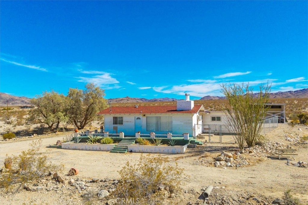 This property offers a truly unique opportunity to live immersed INSIDE the natural beauty and serenity of Joshua Tree National Park. With its expansive 10-acre landscape, complete privacy, and proximity to outdoor activities like hiking and rock climbing, it’s perfect for those seeking a retreat or a personal sanctuary. The three structures—main home, garage, and work shed—provide a flexible foundation for renovation and customization to realize your vision. The house has 2 bedrooms and 2 baths. The detached double garage and carport will keep the cars cooler. All structures can use some updating. Being just two miles from the North Entrance Station, you’ll enjoy convenient access while maintaining seclusion. Whether you’re an outdoor enthusiast, an artist, or someone looking to escape the hustle, this property invites you to craft your ideal desert sanctuary amid one of California’s most iconic landscapes. LOCATION, LOCATION, LOCATION!!!