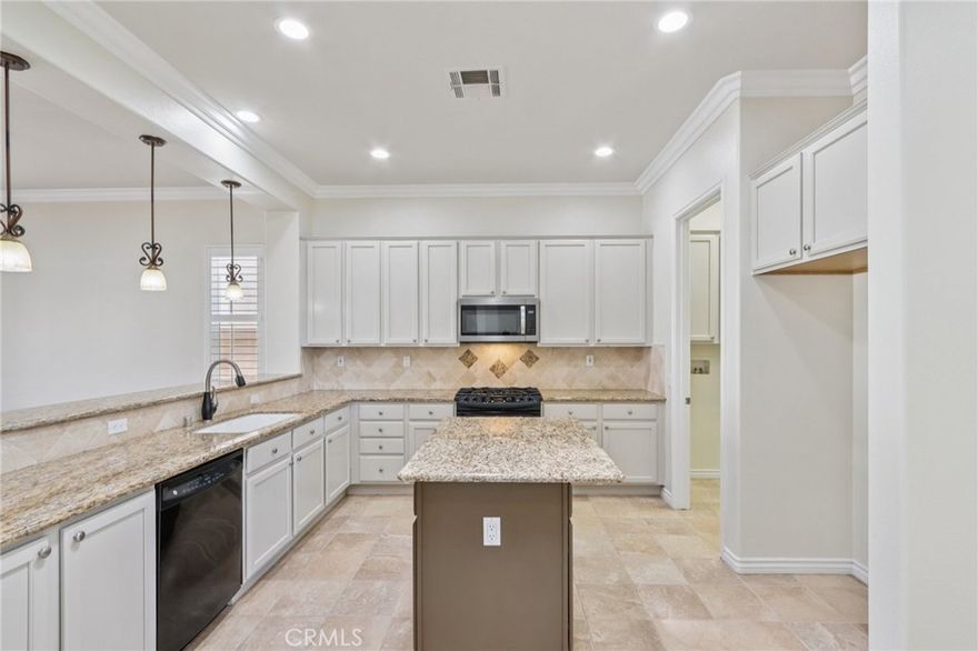 Step into elevated living in the heart of Solera Diamond Valley by Del Webb, one of the region’s premier 55+ communities.  This thoughtfully upgraded residence is a rare find, offering elegant design, high-end finishes, and a seamless indoor-outdoor lifestyle.  Every detail—from the lush landscaping to the custom interior touches—has been curated for both comfort and sophistication.  From the moment you arrive, you’ll be captivated by the gorgeous professional landscaping, including a mature tree in the front parkway, and a welcoming security screen front door that opens to a glass inlay front door, creating a warm and inviting entry.  Step inside to discover plantation shutters, crown molding, and gorgeous upgraded flooring that flow seamlessly throughout the open-concept layout. The living room features a cozy fireplace, a custom built-in, and direct access to a versatile office space complete with a built-in desk and bookcases—ideal for remote work or quiet hobbies.  The chef’s kitchen is a standout, boasting granite countertops on the island, bar top, and work surfaces, white cabinetry, and an elegant tile backsplash.  Upgraded fixtures enhance both style and function throughout the home.  Retreat to the spacious primary bedroom suite, offering ample room to relax. The en-suite bath includes a step-in shower, a soaking tub, and a walk-in closet with custom built-in shelving, delivering the perfect balance of luxury and practicality.  Additional highlights include a laundry room with extra storage cabinetry and a utility sink, ideal for added convenience.  Enjoy the Southern California weather year-round on your California-style back patio, complete with stamped concrete, flower beds, and more of the home’s stunning professional landscaping—perfect for morning coffee or evening gatherings.  This home is truly turnkey and ready for its next chapter. Don’t miss your opportunity to live in a vibrant, active community filled with top-tier amenities.