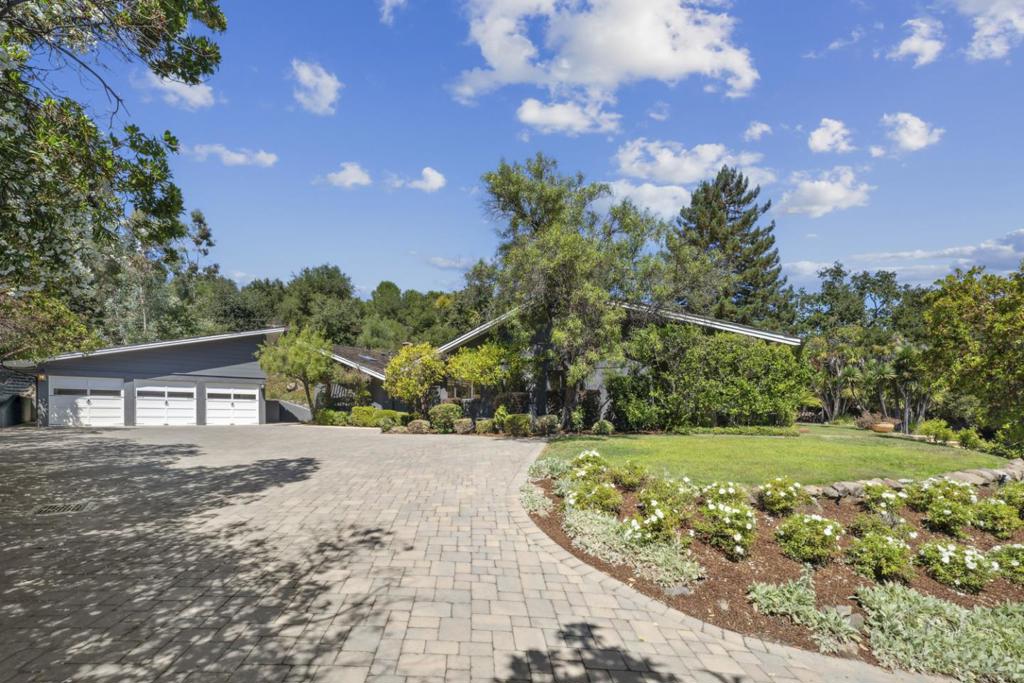 Stunning Santa Barbara Style Estate tucked away on a private cul-de-sac. This single-level home offers an elegant living room with fireplace, a gourmet eat-in kitchen with granite countertops that opens to the spacious family room, and a formal dining room ideal for entertaining. A private office with fireplace provides the perfect work-from-home retreat. The exquisite primary suite features a luxurious bath, while the serene outdoor setting showcases a sparkling pool and space to design a private garden. Located within the highly sought-after Las Lomitas School District.