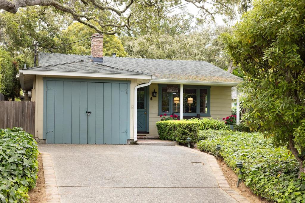 Discover the epitome of coastal cottage living in downtown Carmel-by-the-Sea's highly sought-after Golden Rectangle. This single-level storybook home built in 1939 provides a timeless 2-bedroom, 2-bath retreat, featuring vaulted open-beam ceilings and wood-clad windows that bathe the interiors in natural light. The kitchen pairs durable granite countertops with a quaint breakfast nook, perfect for relaxed living. Other features include the adorable dutch-door entry, the cozy living room with a classic brick fireplace and delightful cottage-style accents, and the primary suite with a luxurious soaking tub. Outside, the fully fenced 4,000 sqft lot includes a deck/patio perfect for al fresco dining and a one-car attached garage plus driveway parking. Sited just six blocks from Carmel Beach and moments from world-class galleries, restaurants, and boutiques, this home seamlessly fuses serene private living with vibrant village access. This charming Carmel cottage presents a wonderful opportunity to live in one of California's most enchanting oceanside villages.