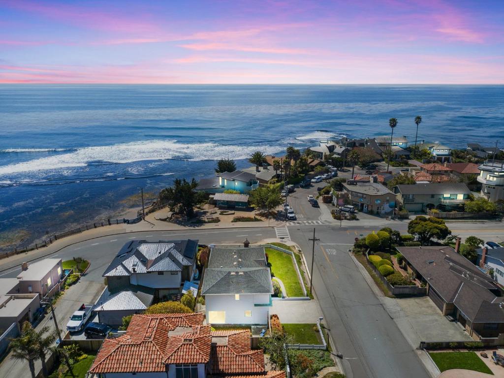 102 32nd Ave, Vintage Beachside Charm in Pleasure Point. Nestled in the iconic Pleasure Point neighborhood of Santa Cruz, steps from the ocean, sits a charming beach house. Built in 1960, this 3bed, 2bath cottage radiates vintage beach-house charm and embodies the relaxed, laid-back vibe of a classic coastal retreat. From the living room, picture windows frame stunning ocean views. In the mornings, you can sip your coffee and watch surfers carve waves at the iconic Pleasure Point surf breaks all without leaving the comfort of your couch. Every morning, golden sunlight dances across the blue water, and each evening the lights around the bay twinkle to life, offering a magical backdrop to your life by the sea. The layout offers both cozy nooks for quiet relaxation and open areas that flow easily for entertaining family and friends. A 2-car garage provides plenty of room for vehicles, surfboards, bikes, and beach gear. On the ocean side of East Cliff Dr a county-maintained seawall protects the coastline here, so you can enjoy your waterfront lifestyle without worrying about bluff erosion. A rare chance to own a slice of Pleasure Point paradise. Don't miss the opportunity to make this dreamy beach house your own. Wake up every day to the sound of the surf and the sight of the sea.