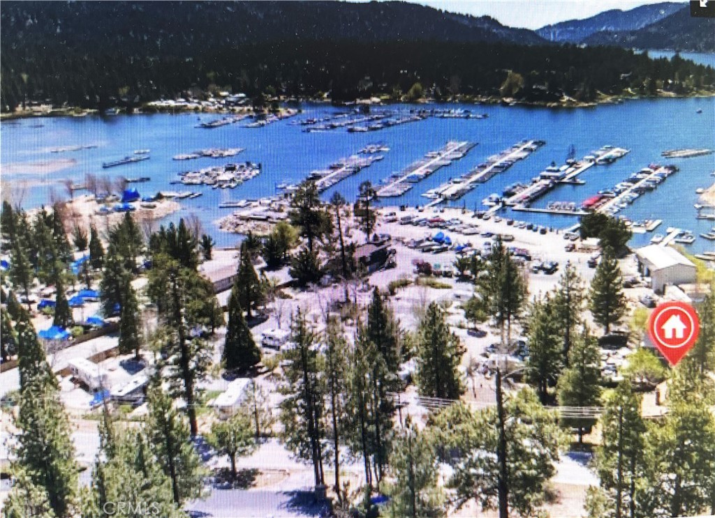 Beautiful cabin in the Heart of Big Bear Lake! This charming cabin is ideally located close to the marina and the famous downtown Village! The living area features modern flooring that blends seamlessly with the classic cabin aesthetic, while insulated walls and windows ensure a comfortable ambiance throughout the year. Tasteful upgrades have been made to the home, maintaining the rustic allure you seek in a mountain getaway while enhancing its functionality and comfort. Outside, the property delights with its inviting deck that offers peek-a-boo views of the shimmering lake. Whether you're enjoying a morning coffee or a starlit dinner, the outdoor space is perfect for soaking in the natural beauty of Big Bear. The fully fenced backyard provides a private oasis for relaxation and gatherings, framed by a classic picket fence. Located just a stone's throw from Holloway's Marina, you'll enjoy instant access to the lake, making water activities a delightful part of your daily routine. Additionally, the cabin is conveniently close to the village, alpine magic slide, and Gilner Point, ensuring that adventure and amenities are never far away. As one of the best-priced homes in the area, this cabin is a rare find.