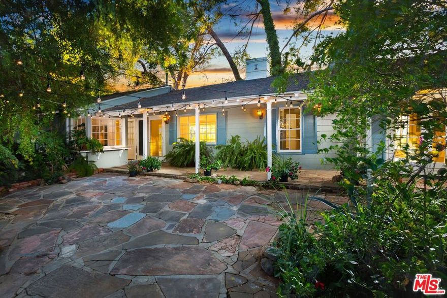 Located just off Mulholland down a private road at the end of a cul-de-sac sits this enchanting home. Offering 2 bedrooms and 2 bathrooms nestled on almost 2 acres of lush green property. Guests are immediately welcomed to the spectacular city and canyon views. The home boasts tasteful updates and beautiful hardwood throughout, with a focus on maintaining its classic charm. The Master offers an en-suite sitting area with a fireplace and an additional den/studio space. Lush outdoor space with greenery all throughout the property and water ponds. Beautiful areas to sit outside and listen to the nature with breathtaking mountain views.  Truly worth seeing to appreciate! Enjoy a break from the city in this secluded retreat. Providing the utmost privacy, while conveniently being only minutes to either Sunset or Ventura Blvd.