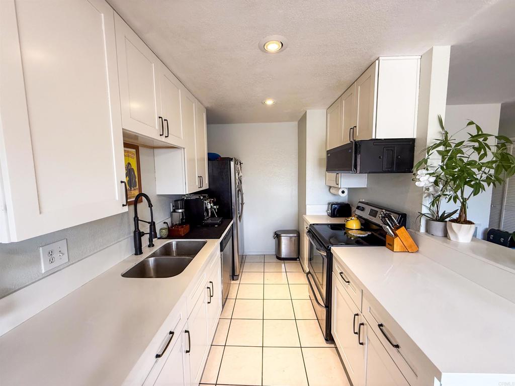 Upstairs unit with modern upgrades! Features include a full-size washer & dryer in-unit, quartz countertops, stainless steel appliances, vinyl plank flooring, blackout shades, and an upgraded bathroom. Bright open layout in a gated community with easy access to freeways, shopping, and dining. Turnkey and move-in ready!