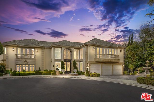 Extraordinary 10,000+ sq. ft. Italian Villa with tennis court and beautiful canyon/city views is situated on a 26,000+ sq. ft. lot at the end of a private cul-de-sac in the prestigious guard-gated community of Bel Air Crest. Completely renovated, this estate exudes style & sophistication with gorgeous ornate detailing & walls of French doors that open to stunning terraces & overlook lush vistas. A 2-story beveled glass & iron wrought front door leads to the impressive formal foyer with dual sweeping staircases, marble floors, & hand-painted ceiling with domed skylight. Stunning living room with intricate Venetian plaster & coffered ceilings, formal dining room, & chef's kitchen with oversized center island & gourmet appliances. Upstairs is a luxurious master suite with dual oversized baths & walk-in closets, sitting room/gym, sauna, & an additional 3 bedroom suites. Expansive lower-level entertaining space with games room & bar, abundant patio space, and private lagoon-style pool/spa.