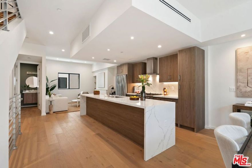 Ask us about the special Low Interest Rate, Seller-Paid Buydown options available through two large lenders, limited time offer! Embrace striking modern architecture and refined coastal living in this newly built single-family home in the heart of Mar Vista, just minutes from Venice Beach and Abbot Kinney. The private primary suite occupies its own level with a spa-inspired bath, walk-in closet, and sunlit terrace, while two additional ensuite bedrooms offer comfort and privacy. Thoughtfully designed with natural textures and clean lines, the open-concept layout features a custom chef's kitchen, warm fireplace, and seamless indoor-outdoor flow. A rooftop deck with sweeping city and mountain views and a private 2-car garage with direct entry complete this contemporary coastal retreat.With the lowest price per square foot in the neighborhood, this home delivers unmatched value in one of Los Angeles's most sought-after locations. Listing photos represent another home in the same community; some trims and finishes may vary.