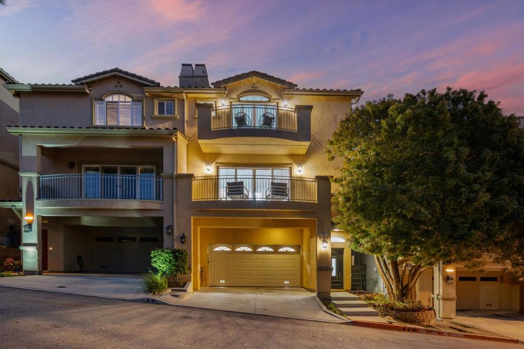 Breathtaking views set the tone for this thoughtfully designed multi-level home at 811 La Montagne Place, where space, style, and flexibility come together seamlessly. Enjoy an open-concept layout with soaring ceilings, sun-drenched living spaces, and a chef's kitchen featuring granite countertops, stainless steel appliances, and a large central island. The expansive family room with fireplace and balcony is perfect for entertaining or relaxing, while the low-maintenance backyard offers artificial turf for effortless outdoor enjoyment. Upstairs, the luxurious primary suite boasts its own balcony, stunning views, a spacious walk-in closet, and a spa-like bath with dual vanities. Three bedrooms, 2 full bathrooms upstairs, and a half guest bath on the main level, provides comfort for all. A bonus room with full bathroom off the garage is ideal for a home office or studio. Two car garage with two Tesla chargers offers rare functionality. With upgraded finishes throughout and a prime location near major tech employers, this home offers easy access to 280 and 101, BART, Caltrain, SFO, and neighborhood favorites like Costco, Trader Joes, Safeway, and Kaiser Permanente. Nearby Orange Park and the scenic trails of San Bruno Mountain just minutes from your front door.