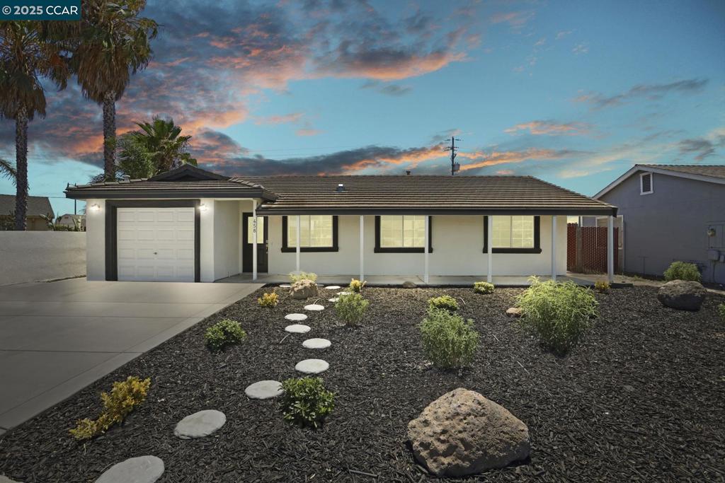 Start with great curb appeal—a brand new driveway, freshly landscaped front yard with sprinklers, new exterior paint, and an attractive tile roof. Step through the new front door into a beautifully refreshed interior featuring fresh paint, new vinyl plank flooring throughout, modern LED lighting, stylish window coverings, updated ceiling fans, and a kitchen with brand new appliances. Truly move-in ready. The backyard offers a large yard with sprinklered sod and a covered patio, perfect for outdoor entertaining with no rear neighbors. Even the attached garage is finished with sheetrock and fresh paint. This is a rare opportunity to own a charming three-bedroom, two-bath home at one of the lowest price points in Lathrop. All this and more is located just minutes away from parks, schools and the rapidly growing Lathrop Marketplace anchored by Target and Sprouts, with several new developments on the way including Sam’s Club, Sutter Health Urgent Care, Ono Hawaiian BBQ, and many more, plus Lathrop’s first Chick-fil-A, which opened recently.