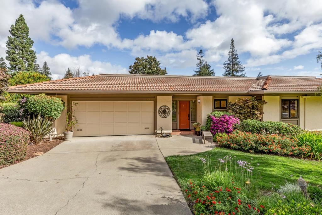 Located in the private, gated Rancho Deep Cliff community of just 65 homes, this beautifully appointed home enjoys spacious living and entertaining spaces, abundant natural light, and serene outdoor space. Throughout the home you will find gorgeous hardwood floors, custom moldings, and a warm, inviting color palette. The living room offers a focal-point gas fireplace with a limestone surround, built-in cabinetry, sliding glass doors to a charming atrium patio, and French doors to the back patio that spans the width of the home with views of the greenbelt and direct access to the community pool. A formal dining room opens to the granite-appointed eat-in kitchen with an extended peninsula counter with seating, casual dining area with a large bay window, and premium appliances including a Wolf gas range. The privately located primary suite has French doors to the back patio and boasts abundant storage in three closets, and a spa-like en suite bath with limestone finishes. The second bedroom, or ideal home office, has a substantial built-in workstation and a convenient Murphy bed. A fabulous lifestyle awaits with a community pool, gym, clubhouse, tennis courts, meticulously maintained grounds, and private access to miles of hiking trails at Stevens Creek County Park.