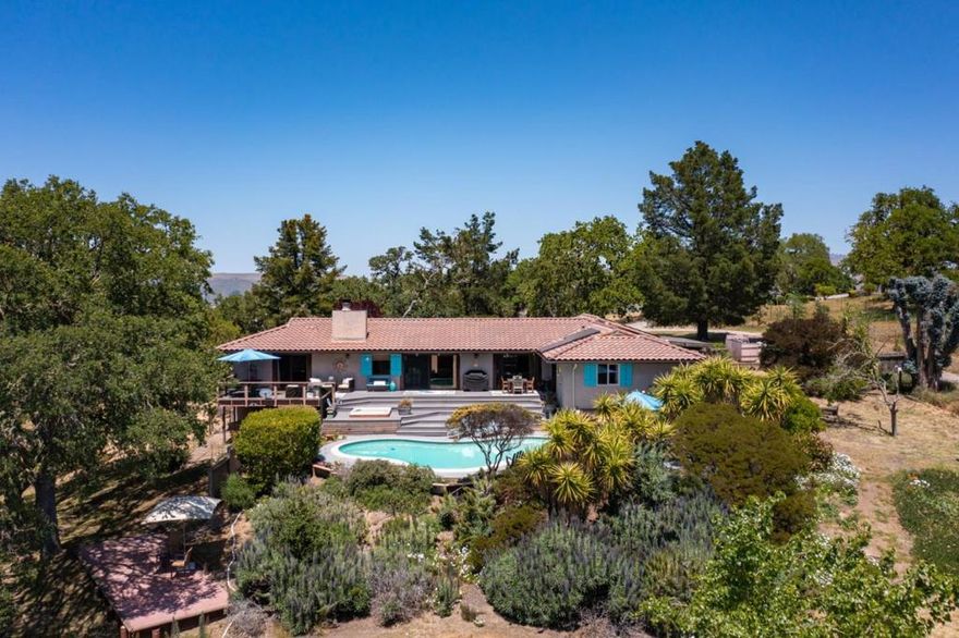 Located just 6 miles from Carmel Village this property is a must see. Experience the perfect blend of privacy, tranquility, and breathtaking views in this meticulously maintained single-level home located in the desirable Sky Ranch Estates. Nestled on a  10-acre property, this exquisite 4-bedroom, 2-bathroom residence has been meticulously maintained and thoughtfully updated. The high ceilings and fireplace create a welcoming ambiance, while the walking closets and air conditioning ensure comfort and convenience.   As you approach this remarkable 10-acre property, you'll be welcomed by a park-like setting where the land meets the sky, revealing incredible vistas of the mountains and the Ventana Wilderness. The outdoor space is a true oasis, featuring a refreshing swimming pool and a relaxing spa, perfect for unwinding after a long day.   The expansive deck is ideally positioned to capture the sunny southern exposure, providing a perfect spot for entertaining or simply soaking in the views.   This property is a must-see for anyone seeking a serene retreat with modern conveniences. Don't miss the opportunity to make this stunning home your own!