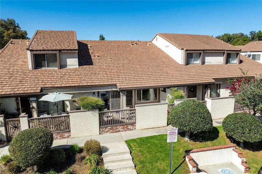 Beautiful townhome in the Highly Sought after Fairways community in Valencia with serene views of the Vista Valencia Golf Course. Enter the gated spacious private patio to access the front door. This home has been meticulously maintained and boasts BRAND new Wood Laminate floors throughout the downstairs and Plush neutral Carpet upstairs. Freshly repainted entire interior. Brand new Stainless steel Range and Microwave Hood vented to exterior. Very open light and bright with newer DUAL pane windows and sliding glass door to patio. ALL the expensive systems updated here too: NEW HVAC in 2019, NEW MAIN ELECTRICAL Panel 2025, New Water Heater in 2024 and Plumbing has been redone and newer fixtures. Open floor plan with large living space and vaulted ceilings. 2 car direct access attached garage allows for side by side parking and additional storage and shelving. Priced 60,000 LESS THAN previous model match. NO MELLO ROOS! FHA and VA approved. EASY FINANCING on this one. RELATIVELY LOA HOA with amazing grounds. FEEL like you are living in a private park with Mature Lush landscaping, trees and lots of grass areas with resort amenities like 3 community POOLS and SPA, TENNIS courts, and Basketball Court. LOCATION is a 10+++ Close to Valencia and Santa Claritas amazing Paseo system, Easy access to 5 fwy, walk to Elementary School and California Institute of Arts as well as College of the Canyons. Restaurants and Shopping close by. Pack your stuff and move in! This is the one!