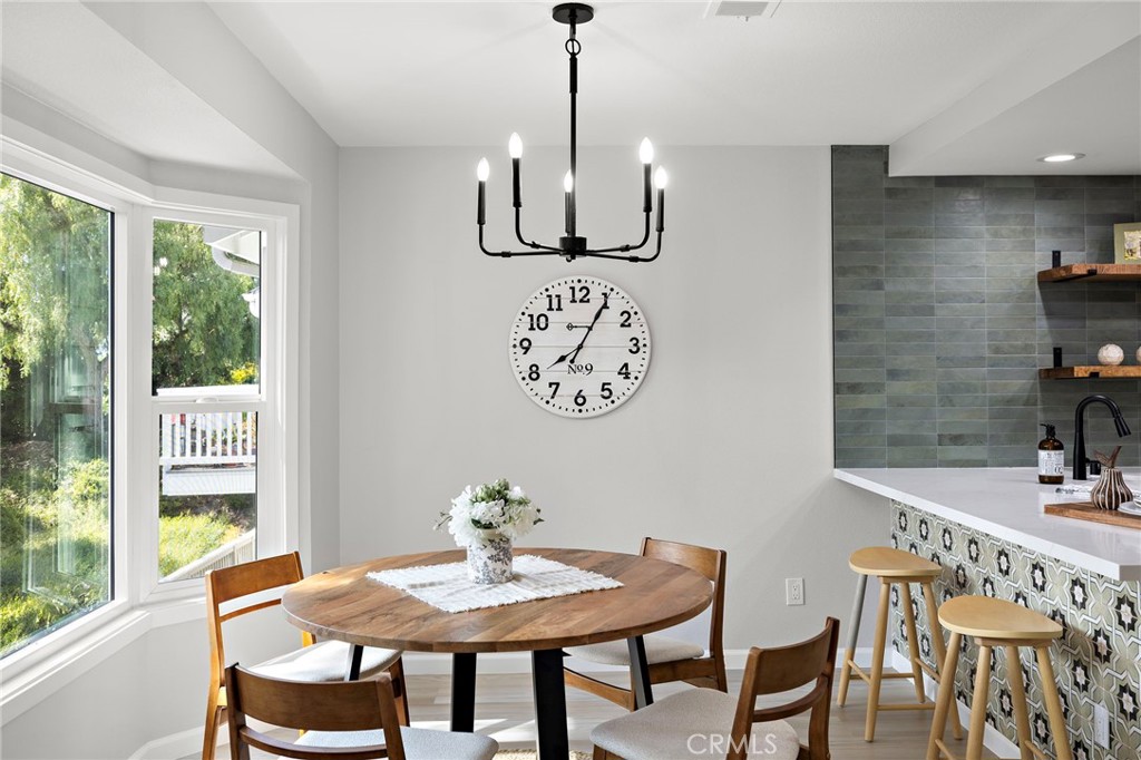 Set in Dana Point’s sought-after Sea Ridge community, 33555 Sea Gull Ct blends thoughtful design with laid-back coastal living. This 3-bedroom, 2.5-bath home features a rare reverse floor plan, designed to maximize natural light, privacy, and flow across two beautifully updated levels.
At the entry, a spacious deck welcomes you in, setting the tone for relaxed mornings or sunset gatherings. Step inside to find an interior that’s been completely updated, with fresh paint throughout, new wood-like flooring, and carefully curated designer finishes that give the home a clean, modern edge. The main living area sits on the top floor, where vaulted ceilings and large windows create an airy, light-filled space. The living and dining rooms flow effortlessly into a updated designer kitchen, featuring hand-crafted tile, quartz countertops, and streamlined cabinetry. A striking half bath nearby adds personality, with custom wallpaper and upscale details.
The primary suite, also located on the top level, offers a quiet retreat with a remodeled en-suite bath complete with double sinks, quartz counters, and a serene, spa-like feel. Just off the living room, a balcony invites you to enjoy treetop views and ocean breezes, enhancing the home’s indoor-outdoor lifestyle.
Downstairs, two generously sized bedrooms share a full bathroom and are situated near a dedicated laundry room. One of the bedrooms includes sliding glass doors that open directly to the patio and backyard, creating a seamless connection to the outdoors.
Sea Ridge offers a peaceful, well-maintained environment with desirable community amenities including a resort-style pool and spa, tennis court, and a clubhouse. All of this is just minutes from Dana Point Harbor, Strands Beach, Salt Creek, walking trails, and the vibrant shops and restaurants of the Lantern District. Whether you’re looking for a coastal full-time residence or a weekend retreat, this turnkey home delivers both style and lifestyle in one of Orange County’s most charming beachside enclaves.