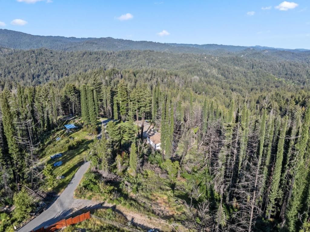Let your imagination run wild at 1410 Pinecrest Dr. Located just minutes from the idyllic mountain town of Boulder Creek and all that it has to offer, including local grocers, world-class hiking and mountain biking trails, and more, all while feelings like you're in your slice of paradise. Complete with a well paved road and driveway leading to the parcel. It also features Underground Electricity service from PG&E and 4 shared wells between the eight homes that comprise the Pinecrest Home Owners Association. The association fees consist of $25 per month for water and the road maintenance agreement is included with the property taxes. Wish upon a shooting star with crystal clear night skies, or spend your mornings waking up slow while listening to the native birds chirping and Mount Umunhum emerges from the fog in the distance. Don't miss out on your chance to build the home of your dreams in some of the most prime California real estate.