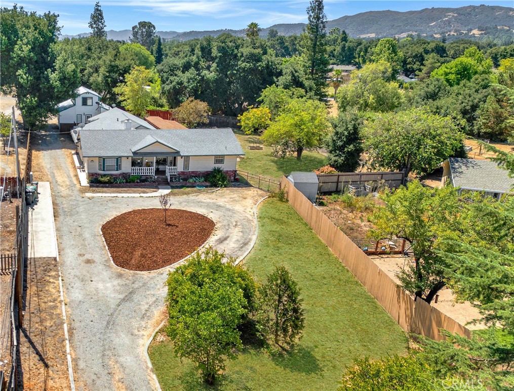 Discover this private two-unit property nestled among mature oaks, just minutes from the vibrant, revitalized Downtown Atascadero, Lake Park, and only 20 minutes to Downtown San Luis Obispo. Situated on a spacious 27,500± sq. ft. lot, the property is fully enclosed with privacy fencing and features a main residence paired with a charming barn-style ADU, ideal for multi-generational living or rental income potential! The main home offers a thoughtful layout with two bedrooms and 2 full baths, plus an office with fireplace, and a spacious living room that flows into a cozy dining area and kitchen. Warm wood floors, custom craftsman details, built-ins, and stained-glass accents add unique character throughout. A front covered porch with durable Ipe hardwood lends itself a comfy covered entry to watch the world go by! There’s an attached oversized garage that provides ample storage, and there's even a potential studio or office space with a half bath off the garage, unfinished and ready for your personal visions! Each unit enjoys its own generous size private yards and parking areas. The back unit is set apart from the main home and features one-bedroom, one-bath on the main floor, and upstairs a large loft, bonus room and second bathroom. The ADU has a full kitchen and open-concept dining/living space that leads to a shady backyard. Set on a picturesque 0.67-acre oak-studded lot, the property offers both usable land and a serene setting for each unit. Both perfect for entertaining, gardening, or simply relaxing in this quite location. Whether you’re seeking an income-producing property or a peaceful multi-generational haven, this well-appointed retreat blends charm, character, and functionality in a truly tranquil Atascadero setting!
