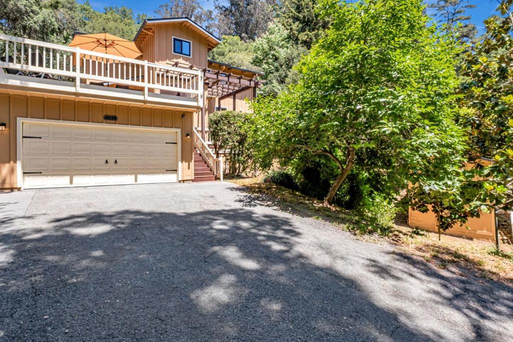 Idyllic country home & detached studio unit on a private sunny hillside surrounded by nature. Soaring open beam ceilings & abundant windows stream in plenty of natural light. Tile & wood floors with carpet in 2 bedrooms. The main floor has a bedroom & updated bathroom and laundry closet. Upstairs are 2 bedrooms & an updated bathroom. The kitchen features freshly painted cabinets, tile counters and stainless steel appliances. Ample dining area to host dinner parties & game night! The cozy wood stove in the living room provides a warm place to read, crochet, or sip your favorite tea as you wind down the day. Seamless indoor/outdoor flow from the living room & dining room to the rear yard where you can soak in the hot tub, make s'mores around the gas fire pit & relax in your peaceful hammock. Expansive sun drenched deck has amazing views - ideal for BBQing & entertaining! Beautifully blooming Magnolia trees, Pear & Persimmon trees & Grapes! Garden boxes to grow your favorite veggies. 2 car garage with EV Charger, workbench, and a utility room. Detached studio unit w/ bathroom & small yard/deck/parking is away from main house. Great neighborhood & excellent schools! Easy drive to Freeways & Beaches. Centrally located to Monterey/Carmel & Los Gatos/Bay Area. Fantastic opportunity!