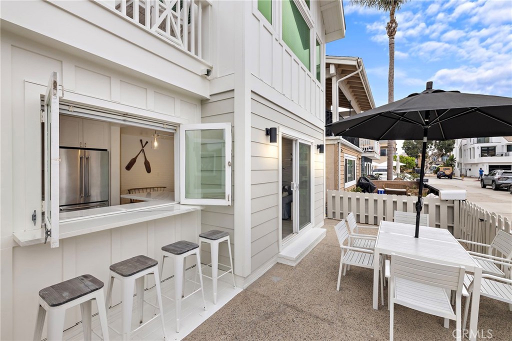 Living large at 207 40th Street, Unit A downstairs! One of two available units, sold separately or together, each with a coveted active short-term lodging permit fully transferable to the new owner. Totally remodeled and professionally furnished, this property is ready to enjoy from day one as a getaway, family beach pad, or high income-generating rental. The interior is styled in a coastal urban-chic aesthetic with light wood accents and beach-inspired tones. This 2-bedroom, 2-bath layout is light, bright, and built for the beach lifestyle, including a private primary ensuite. The front patio sets the tone with a built-in bar, al fresco café window, BBQ, and dining area—perfect for gathering after the beach or bay. Additional highlights include air conditioning, a private outdoor shower and two tandem parking spaces in the oversized 4-car garage. Everything you need is already here from the furnishings to the beach gear making this an easy, turn-key operation. Located just 11 houses from the sand and 4 houses from the bay in one of Newport Beach’s most consistently desirable zones of the Newport Peninsula. (see the upstairs unit also for sale @ 207 40th St #2)