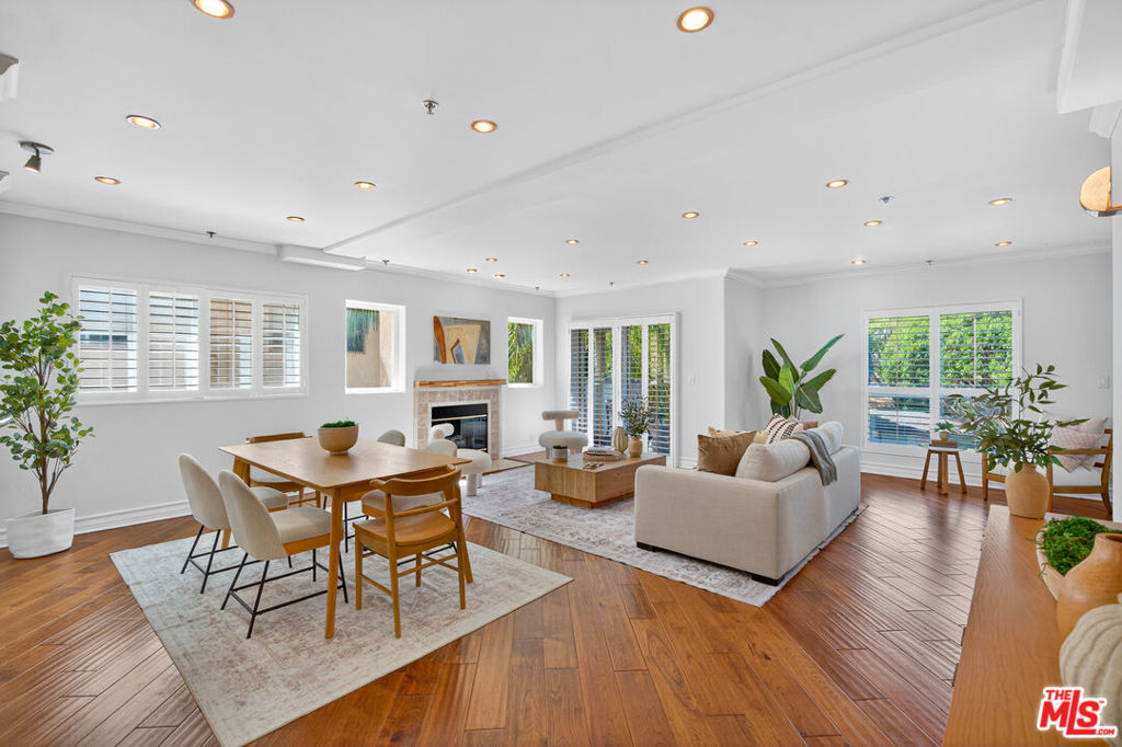 This stunning, front facing expansive 2-bedroom, 2-bathroom residence showcases stylish hardwood flooring throughout and boasts spacious living, dining, and kitchen areas. Large windows flood the interior with natural light, while a cozy gas fireplace anchors the living room, creating a warm, inviting ambiance perfect for both entertaining and relaxing. The gourmet kitchen features sleek cabinetry, granite countertops, and stainless steel appliances. Additional highlights include an in-unit washer and dryer, ample storage, and modern finishes throughout. Retreat to the oversized primary suite, a peaceful sanctuary complete with custom built-in shelving, a generous walk-in closet, and a spa-inspired en suite bathroom featuring double vanities, elegant tilework, and a soaking tub. The second bedroom is equally roomy ideal for guests, a home office, or a creative space and is conveniently serviced by a well-appointed second bathroom just steps away. Situated in a secure, well-maintained building with gated parking and elevator access, this exceptional unit places you just minutes from the sandy beaches of Santa Monica, world-class dining, boutique shopping, parks, and top-rated schools. Modern luxury, prime location, and effortless living welcome home.