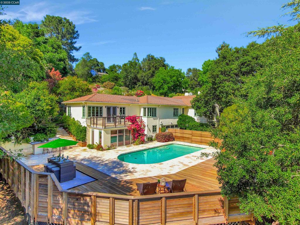 OPEN THIS SUNDAY AUGUST 17--2-4 This 4+ bedroom, 3 bath home is set on a.78-acre private lot. Step inside to a beautifully renovated eat-in kitchen with solid wood cabinetry and premium finishes. Adjacent to the kitchen is a spacious family room with a large fireplace. This versatile space opens to a charming outdoor brick patio, and also connects to the formal dining room. Completing the main living area is an elegant living room, distinguished by its own fireplace and an oversized picture window showcasing the wonderful wide plank wood floors found throughout the home. All bedrooms and a flexible bonus room are ideally situated on the main floor. The private primary suite features direct access to a serene deck with views overlooking the swimming pool. On the lower level, discover a second family room with direct access to the pool area with its ample patio space. This unique property allows you to immerse yourself in the beautiful terraced garden, enhanced by its levels of lush greenery and private nooks. And, for the golfer, there is a putting green that provides the perfect spot to practice your short game.