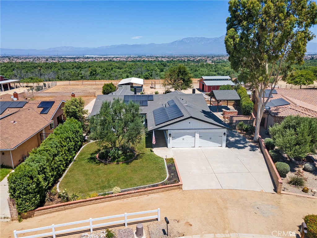 Welcome to 2777 Shadow Canyon Circle – A Stunning Equestrian Retreat in the Heart of Norco!
This beautifully remodeled single-story home sits on a level 0.63-acre lot in the highly desirable area of Horse Town USA, offering panoramic views of the scenic Norco Bluffs. Located on one of the most prestigious and sought-after streets in Norco, this unique property boasts 3 bedrooms, 3 bathrooms, and over 3,100 sq ft of light-filled open living space.
Step inside and immediately feel the seamless flow of the open floor plan, with clear sightlines from the entry area through the expansive family room and out to the beautifully landscaped backyard. The chef’s kitchen is a showstopper, featuring a massive quartz island with seating for 6–8, all-new custom cabinetry, stainless steel appliances including double ovens, and a built-in custom refrigerator. Just beyond the kitchen, you’ll find a spacious laundry room and not one, but two oversized pantries and closet space.
The luxurious primary suite offers a peaceful retreat with high beam ceilings, a cozy raised-hearth fireplace, direct backyard access, a large walk-in closet, and a spa-inspired en-suite bath with dual sinks and an oversized walk-in shower for two.
Equestrians and outdoor enthusiasts will fall in love with the custom backyard, complete with two fully enclosed horse stalls, a large barn/workshop, a generous riding arena, and a raised, fenced garden area. Enjoy evenings under the expansive covered patio, fire up the built-in BBQ, or pick fresh fruit from your fruit trees in your own orchard. There's also a chicken coop, a large open yard space and an open grassy area, enclosed by a low fence – perfect for pets or play.
The extra-deep garage easily accommodates 4 vehicles plus a work station, there is even a sauna in there, while there is gated RV parking along the side of the home which provides additional space for trailers or recreational vehicles.
With easy access to horse trails, the riverbed, and breathtaking sunset views on the mountains beyond, this is a rare opportunity to embrace the Norco country lifestyle at its finest. Come see it before it's gone!