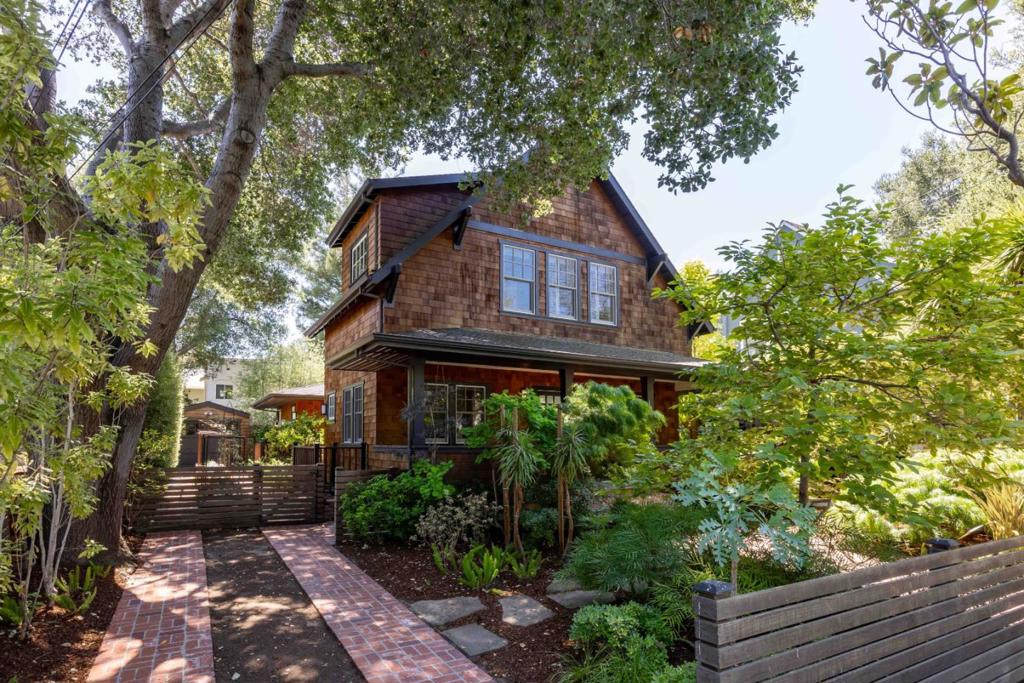 Brimming with curb appeal, this beautiful Craftsman-style home blends timeless architecture with modern comfort in a prime location. A charming brick pathway leads to a spacious covered front porch, opening to over 3,100 square feet of interiors filled with natural light, fine millwork, and rich hardwood floors across three levels. At the heart of the home, the great room features a living area with fireplace, a walk-out dining room, and a chef's kitchen with Thermador and Bosch appliances. Four comfortable bedrooms provide space and privacy, complemented by an office and a versatile lower level that adapts to a variety of lifestyle needs. The peaceful backyard offers a brick patio and large deck with built-in fire pit, perfect for entertaining, while additional highlights include air conditioning and a detached garage used for storage. Access to top-rated schools Addison Elementary, Greene Middle, and Palo Alto High add the finishing touch (buyer to verify eligibility).