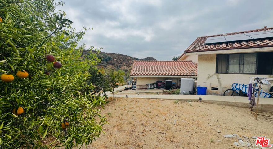 Nestled on a nearly one-acre lot, this spacious 3-bedroom, 2-bathroom home offers a flexible lifestyle with endless potential for farming, gardening, or outdoor recreation, plus room for horses, cows, or other farm animals. Enjoy panoramic mountain views and tranquil local winds from a thoughtfully designed, easy-maintenance core living space, with opportunities to add workshops, sheds, or a barn. The generous layout supports an ADU in the unit under the house, enhancing versatility for guests, family, or income. Located near the 5 and 215 freeways and close to Silverwood Lake, Lake Gregory, Glen Helen Regional Park, Rio Bonito Falls, and Kimbark Canyon, this property presents waking-up-to-mountains mornings, refreshing breezes, and the chance to craft your perfect, expansive lifestyle all in one place.
