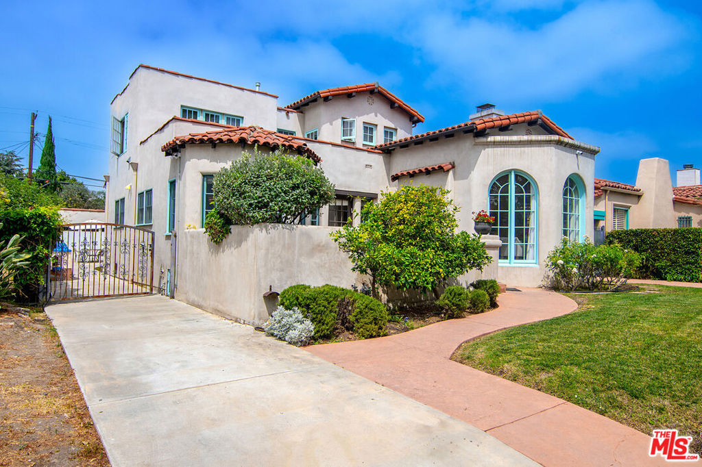 Originally built in 1928, and entirely remodeled and a second floor added to the house in 2007, 131 S Martel now has 6 beds and 4.5 baths over 3860 sq ft on a 7006 sq ft lot in a prime Miracle Mile location close to The Grove and Pan Pacific Park! The front courtyard brings you to a glass door entrance and a center hall foyer with living room on one side and dining room on the other. The living room has floor to ceiling arched windows at the front and a statement fireplace as the focal point of the room. The large formal dining room is surrounded by windows. The remodeled wood kitchen has abundant cabinetry and countertop space, a center island, double sinks, oversized fridge and freezer, and built in breakfast bar. A family room with built-ins drenched in sunshine is right off the kitchen and opens to the yard. There's a great office downstairs! There are 5 beds +large office and 4.5 baths, generous closet space, and remodeled bathrooms. Hardwood floors, dual zone central HVAC, new solar panels + battery back-up system (that saves the current owners over 5k a yr in utility bills.) A grassy yard, a garage for storage, and a tesla charger, and battery back up solar panels round out the offering. The location is central and amazing, right near The Grove, Pan Pacific Park, world class shopping and restaurants.
