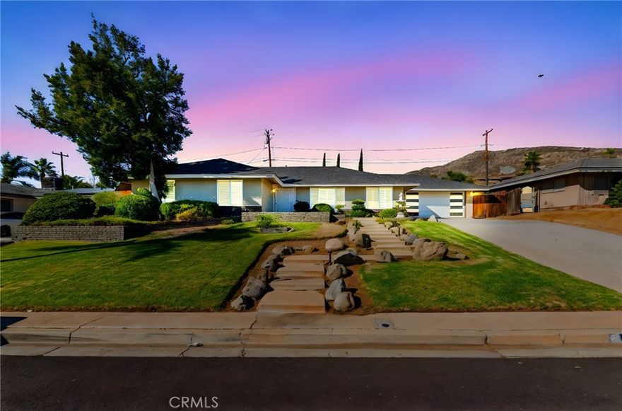 This beautiful pool home offers the best of comfort and style in a beautifully updated five-bedroom single-story design, perfectly positioned in a quiet Moreno Valley neighborhood framed by mountain views. Step inside to a bright and inviting living space where vaulted ceilings and large windows fill the home with natural light. A cozy fireplace anchors the living room, creating a welcoming atmosphere for family gatherings or relaxing evenings.



The kitchen combines elegance and function with rich granite countertops, stainless steel appliances, and custom cabinetry that offers abundant storage. It opens seamlessly to the dining and living areas, making it ideal for entertaining or everyday family life. Each bedroom provides generous space, with the primary suite offering a peaceful retreat complete with an updated bath and views of the backyard. Thoughtful upgrades, including new flooring, lighting, and modern finishes, give the home a fresh, refined feel throughout.



The backyard is your own private escape, featuring a sparkling pool surrounded by mature landscaping and plenty of room for outdoor dining or play. The finished epoxy-coated garage extends the living potential—perfect for a home gym, workshop, or creative studio. The expansive lot also provides RV parking and additional storage options.



Located near Sugar Hill Elementary and Palm Middle School, this home offers easy access to shopping, dining, and the 60 freeway. Lake Perris and local hiking trails are just minutes away, adding convenience and adventure to everyday living. Whether you’re raising a family or looking for a stylish retreat, this home delivers the perfect balance of luxury, practicality, and California lifestyle charm.