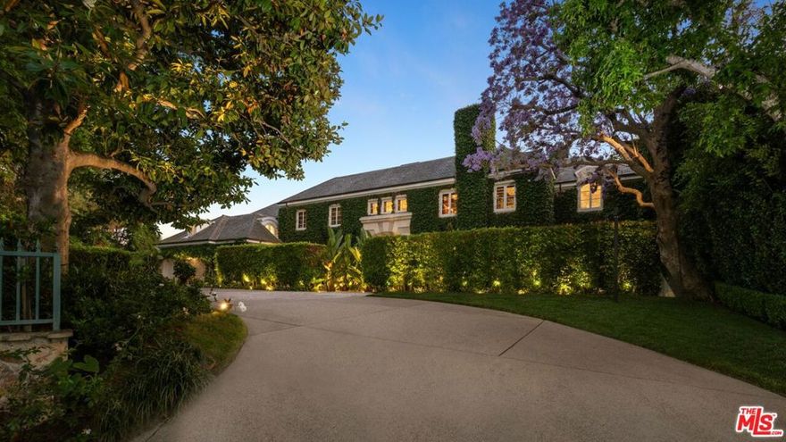 *DO NOT CONTACT OWNER, PROPERTY IS GETTING RE-LISTED WITH SAME BROKERS* Set beside the exclusive LA Country Club, this expansive 1-acre gated estate has been meticulously remodeled to blend old-world glamour with modern elegance. Set back behind a grand, gated motor court, the property ensures unparalleled security and privacy. A grand two-story foyer with warm tones, natural light, and graceful curved lines creates an inviting and sophisticated atmosphere. To the right, a formal living room with a fireplace sets the stage for elegant entertaining, while an office with a bar and coffered ceiling adds timeless charm. Multiple gathering spaces, including a dining room overlooking the manicured grounds, flow seamlessly throughout. The opposite wing features a gourmet kitchen with dual islands and top-of-the-line appliances, a breakfast nook, and a cozy family room that opens to an outdoor dining area shaded by mature grapevines. Upstairs, the expansive primary suite features a fireplace, dual walk-in closets and bathrooms, and a private balcony overlooking the backyard and golf course. Five additional bedroom suites offer ample space for family and guests. Outside, a private oasis awaits. Lush landscaping surrounds a large patio for dining al fresco, firepit, flat grassy lawn, resort-like pool with spa, pool house with additional patio space, tennis court with lights, and an additional deck area that overlooks the impeccably landscaped fifth fairway. Offering a seamless blend of luxurious living and resort-style amenities, this estate provides an unparalleled opportunity to experience the epitome of refined elegance in one of Los Angeles' most coveted locations.