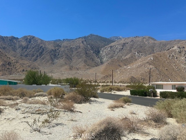 * * * E X C E L L E N T * * * O P P O R T U N I T Y * * * For Owner-Builder or Developer. Large Flat Lot for sale in an upcoming neighborhood just minutes from downtown Palm Springs with GREAT MOUNTAIN VIEWS. On a paved street with utilities nearby. This is unincorporated area of Riverside County which is more flexible on short term vacation rentals. I also have the neighboring lot for sale.