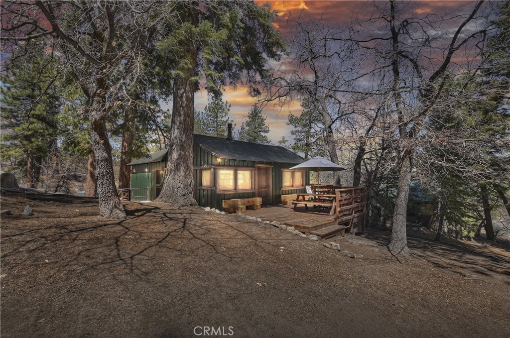 THE PERFECT MOUNTAIN GETAWAY. Perched on a hill, this immaculate one-bedroom, one-bathroom single-story cabin sits amongst the oaks, tall Jeffrey and Ponderosa pines, and massive granite outcroppings all in the middle of the National Forest. Features include knotty-pine walls, newer dual pane windows, a propane stove, a full-size refrigerator, a gas range, and a microwave oven in the kitchen, newer cabinetry, extensive decking, new exterior paint, and even a newer composition roof and comes furnished. Folks, this is an affordable mountain cabin in the National Forest, just a few miles to the Village and the Lake.