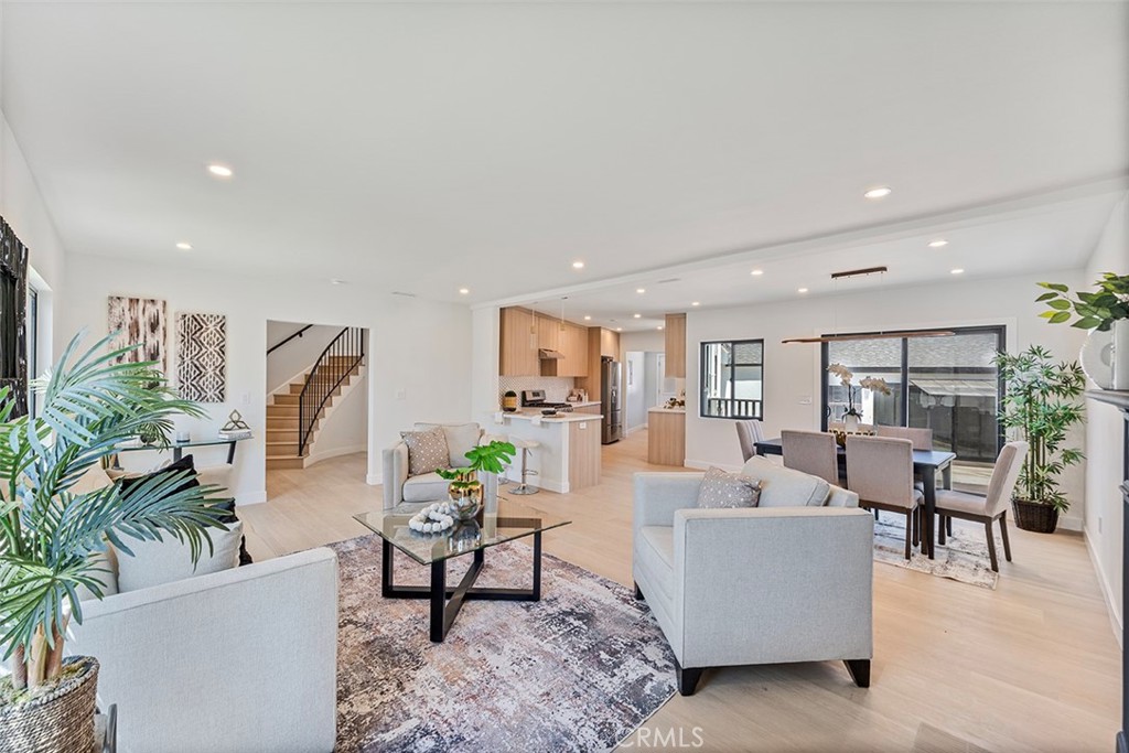 This distinctive home beautifully blends its original character with modern upgrades and formal foyer all set on a professionally landscaped corner lot. From the moment you arrive, the timeless elegance and curb appeal of this two-story residence are evident. The main house offers 3 spacious bedrooms and 3 bathrooms across 1,931 square feet. An additional 552-square-foot permitted studio ADU provides versatility for guests or rental income. The kitchen is both functional and stylish, featuring quartz countertops, stainless steel gas stove paired with an updated range hood, new windows, and ample cabinetry. Adjacent to the kitchen is a newly updated laundry. The expansive living room, centered around a fireplace, offers a more formal gathering space. Upstairs, the primary suite impresses with a wall of built-in closets, a fully renovated en-suite bathroom, and doors that open to a private balcony with sweeping views of the neighborhood hills, the city, and even the downtown Los Angeles skyline in the distance. Two additional generously sized bedrooms and a full bathroom. The detached ADU includes a kitchenette, full bathroom with shower, and A/C mini split wall unit. Additional upgrades include new engineered hardwood flooring, new interior paint, updated electrical panel, new HVAC system for the upper level, fresh exterior paint, and newly installed deck and walkways. Surrounded by lush greenery and mature landscaping, the outdoor space creates a serene backyard retreat perfect for entertaining or relaxing. A private driveway leads to a detached two-car garage with additional storage. Located in the prestigious and centrally located View Park neighborhood—renowned for its architectural beauty and tree-lined streets—this home presents a rare opportunity to own in one of Los Angeles’ most sought-after communities
