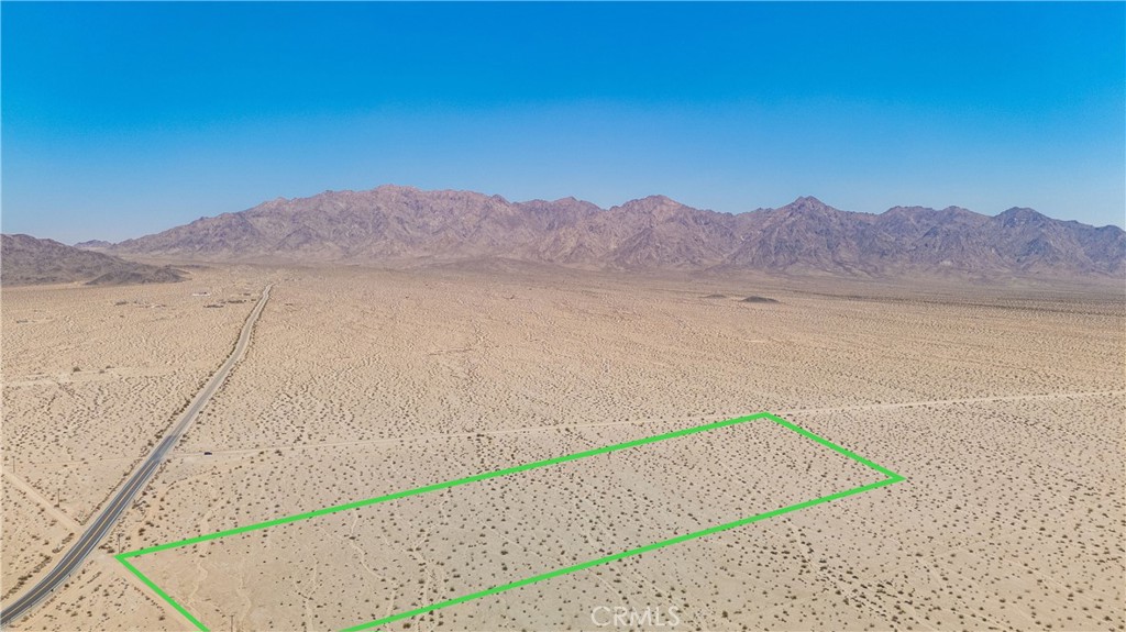 Welcome to Ironage Peak Road, Wonder Valley. This rural parcel is awaiting your vision. The plot is zoned Vacant Land NEC (not elsewhere classified) so has the potential for different uses. This 20 acre lot is just a short drive off of paved Amboy Rd. right before you bend the curve to the back road to Las Vegas passing the extinct Amboy crater volcano and the retro town of Amboy located on the historic Route 66. Panoramic views, beautiful sunrises giving way to surreal sunsets reflecting off of the stark mountains that make up this valley await you. Not to mention very dark skies boasting amazing star filled nights. This large, accessible parcel does have a power pole right at the North/West corner of the lot for easy connection to municipal electricity. The property borders two roads. Ironage Road on front and New Ironage Road on the far end. This may be the ideal location for so many possibilities like a site for glamping, dream luxury home build, a night sky observation point, commercial venture or more. Just under a half hour to the main entrance of Joshua Tree National Park, downtown 29 Palms and it's ever growing number of new and eclectic restaurants like Kitchen of the Desert, The Ground Squirrel, The Happy Cooker and more. As well as under half an hour to the 29 Palms Marine base. Less than an hour to the Mojave National Preserve. Under two hours to Big Bear Lake and just about 3 hours to Las Vegas. Come take a look at this great, large piece of land in the wondrous high desert and make it yours.