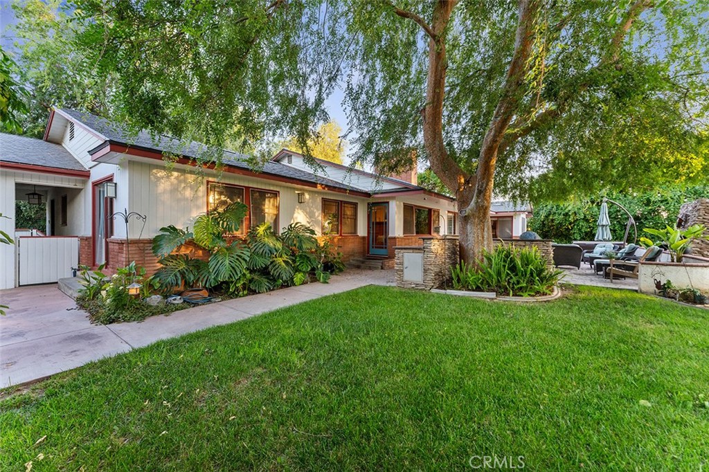 Tucked beneath the dappled shade of mature trees, this custom-built mid-century home in Victoria Woods carries a story as timeless as its design. Built by a skilled shipbuilder who once crafted a beloved Riverside dance hall, the home reflects craftsmanship and thoughtful details rarely seen today.
As guests arrive, they are charmed by the approach: stepping up from the quiet street, passing under a covered pergola, welcomed by a rose garden encircling a fountain that has just the right trickling sounds; a gentle prelude to what lies inside. Entering through a beveled glass door into the cozy den with its inviting fireplace and built ins, the warmth of the home immediately unfolds.
The heart of the home is anchored by an expansive living room, where original built-ins and light fixtures whisper of the home's heritage. The open hallway showcases opposite of custom cabinetry leads to three of the four bedrooms, one of which enjoys private access through sliding doors to the shaded front yard — a tranquil space that lives like a second backyard. The front yard also has a swing bench in front of the entry and has just enough space for a dining set or patio furniture.
Entertain effortlessly in the large formal dining room or gather in the spacious galley kitchen, where built-ins and ample casual dining space offer both functionality and charm. Adjacent to the kitchen, a walk-in pantry and oversized laundry room with direct access to the breezeway, make everyday living simple and efficient.
The thoughtfully designed floor plan includes a separate wing with one of the four bedrooms and its own bathroom — ideal for multigenerational living or private guest quarters. The primary suite opens directly to the backyard through its own sliding doors, allowing for quiet mornings or sunset evenings immersed in nature.
Outdoors, the built-in BBQ and generous entertaining areas invite gatherings both large and small, while the surrounding trees provide filtered light and cool shade throughout the day. The driveway accommodates up to six vehicles, in addition to the two-car garage, ensuring space for both family and guests. (note a basement below)
Perfectly situated near the prestigious Victoria Club, residents can enjoy golf, tennis, pickleball, swimming, fitness facilities, and a vibrant social events just moments from home.
This is not just a house; it’s a story — of craftsmanship, thoughtful design, and the timeless beauty of Riverside living.