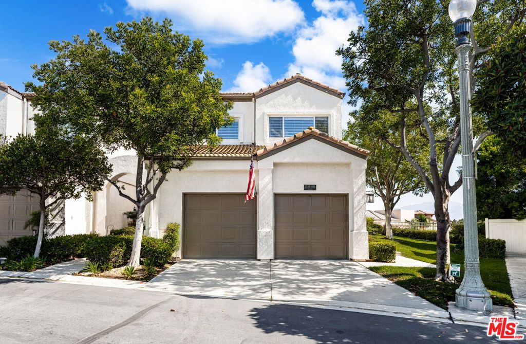 Welcome home to this stunning 3-bedroom, 2 1/2-bath End unit townhome in Corona Ranch, offering modern comfort and stylish design. This home has been tastefully remodeled, luxurious bathrooms, designer fixtures and beautiful flooring, enhancing the spacious, elegant layout. The entry, dining room, and library boast dramatic two-story ceilings, creating a welcoming, open, and airy atmosphere filled with lots of natural light. The cozy family room features a gas wood-burning fireplace, perfect for relaxing. The library is enhanced with custom built-in bookshelves and elegant chandeliers, creating a sophisticated reading and entertaining space. The beautifuly remodeled kitchen includes a generous pantry. Enjoy the privacy of this end unit with a private entrance and a charming wrap-around outdoor patio that is partially covered and offers spacious views. There is plenty of space to start your own garden. The outdoor area features its own separate entrance. Located in a beautiful community with a sparkling pool, this home is close to scenic golf courses, parks, houses of worship, top-rated schools, and major transportation hubs including Ontario Airport and John Wayne Airport. Easy access to the 91 and 15 freeways, and less than 5 miles from Corona Regional Medical Center and Metrolink Station. This beautiful townhome combines comfort, style, and is conveniently located to great shopping and restaurants in a desirable neighborhood.