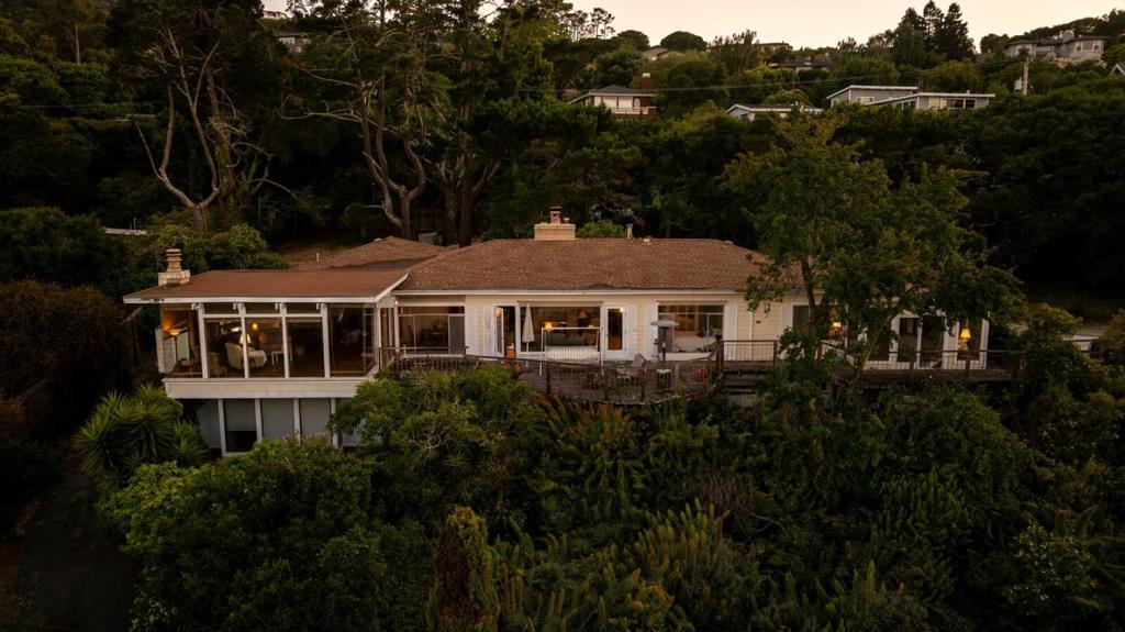 Nestled in the prestigious Tiburon, this 3,165 sqft residence offers an unparalleled blend of serenity & opportunity. An expansive 41,100 sqft lot, this property boasts breathtaking panoramic views of the San Francisco Bay & the iconic beauty of Marin County. The home features 4 spacious bedrooms, 2.5 baths, & an open-concept living area that seamlessly blends indoor & outdoors comfort. Floor-to-ceiling windows frame mesmerizing bay views, flooding the home with natural light. The primary suite with direct access to the grounds. Enjoy exclusive water access from your own beach. This separate parcel provides unrestricted use of the bay and is included. What sets this property apart is its extraordinary development potential & can be subdivided, allowing for the construction of two distinct homes, each with access to separate roads. This rare opportunity is an ideal investment for developers, or those seeking to create a custom compound in one of Tiburon's most coveted locations. Surrounded by lush greenery & just minutes from downtown, top-rated schools, & world-class recreational opportunities, this property offers the best of coastal living with easy access to San Francisco. Schedule a private tour today to experience the beauty & potential of this extraordinary property!
