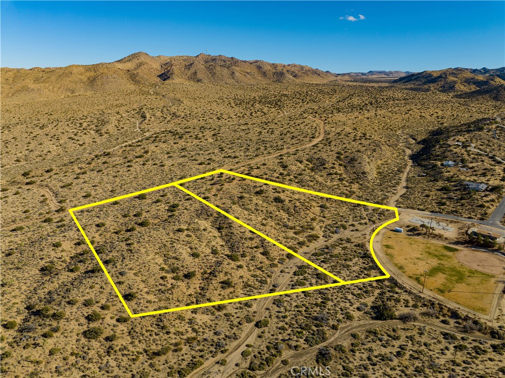 Check out the virtual tour video below:
11.01 Acres – Upper Sky Harbor – Topographical Surveys Paid & Completed
Prime opportunity for builders: Two adjoining parcels totaling 11.01 acres in the desirable Upper Sky Harbor neighborhood of Yucca Valley. Topographic surveys have already been completed and paid for, saving you time and thousands in prep work.
This property is paved-road accessible with utilities available at the street (buyer to verify), making it an ideal candidate for custom homes or a luxury desert build. Elevated for maximum views, the land offers stunning sightlines from Big Bear’s snowcaps to the edges of Joshua Tree National Park.
Located just minutes from Black Rock and Covington Flats, and directly across from peaceful Machris Park. Enjoy a quiet setting that’s still close to town amenities. Build-ready. View-rich. Surveyed and accessible.