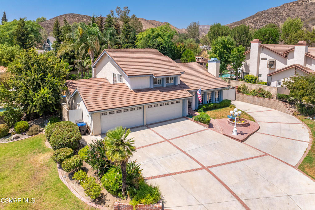 Extremely rare opportunity to purchase this 4 bedroom 3 bath home boasting approximately 2600 square feet on an expansive 14,000 square foot lot highlighted by a 6 car garage, massive paved RV Access and a sparkling pool and spa. Property is ideally located in a quiet cul-de-sac near the north hills of Simi Valley and contains mature trees, grassy area, wide driveway leading to a separately paved RV access, and two garage doors (one garage is tandem with drive through). As you enter the home you will find one of two LARGE living areas with high vaulted ceilings, fireplace, tons of natural lighting and windows, decorative lighting and open to your formal dining area. Dining leads to the kitchen area which has newer stainless steel appliances, lots of cabinet and pantry space, and an eat in kitchen area. Second living area also contains a fireplace, recessed lighting, a ceiling fan and it has direct access to your entertainer's backyard. Backyard boasts large pool with rock waterfall feature and spa, fire pit, built in barbecue, gated RV Access, and an additional grass side yard. Finishing off the main floor is a good-sized bedroom with newer flooring, recessed lighting and a ceiling fan as well as a refurbished FULL bathroom. The second floor is highlighted by the huge primary suite with room for a separate seating area, en suite bathroom containing a separate sunken tub, dual sinks/ vanities, separate shower stall and a walk-in closet. Two additional bedrooms upstairs are good sized and have access to a hallway bath with a shower over tub set up. It is truly a unique property offering additional parking, RV access, pool, downstairs bedroom and amazing location. Property is close to shopping, parks, restaurants and easy access to freeways.