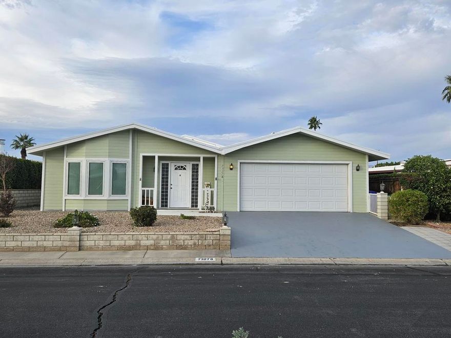Spacious 2BR + Office, Home with rare 2 car, plus tandem golf cart access garage in Palm Desert Greens - You Own the Land! Welcome to this impressively spacious manufactured home in the sought-after 55+ community of Palm Desert Greens Country Club. Offering 1,920 square feet of comfortable desert living, this home is a rare find with features not often seen in the complex--including an attached 2-car garage with a double-sided golf cart door that opens to the patio. Inside, you will find 2 generously sized bedrooms, 2 full bathrooms, and a versatile home office that functions perfectly as a den, craft room, study, or guest space. Laminate flooring in the main living areas enhances the open-concept layout, while the kitchen and bathrooms feature easy-care tile. A built-in hutch adds charm and additional storage. Windows throughout have Double-Paned Glass with most blinds between the glass. The kitchen comes fully equipped with a new 5 burner cooktop, new double oven, and dishwasher.The primary and guest bedrooms include mounted TVs--move-in ready for your convenience! 6 ceiling fans throughout the home help keep it cool and comfortable year-round. Enjoy seamless indoor-outdoor living with covered patio access from both the living room and primary bedroom sliders--ideal for morning coffee or evening relaxation. There is an abundance of built-in storage, closets and cabinets throughout the home. The HOA fee of just $400/month, which delivers incredible value to include Spectrum cable, high-speed internet, trash service, and unlimited golf on the community's private course. You also have access to tennis and pickleball courts, 24-hour manned gated security, a clubhouse with a restaurant, and 22 active social clubs. For families, there's a kiddie park and pool, perfect for visiting little ones.This home offers the perfect blend of spacious living, privacy, and resort-style amenities, all in one of Palm Desert's most vibrant 55+ communities. Don't miss out on this rare opportunity to enjoy a truly exceptional lifestyle.