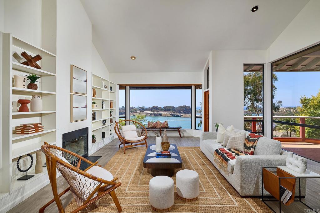 Set above the scenic Agua Hedionda Lagoon, enjoy unobstructed views where the lagoon meets the vast blue horizon of the Pacific Ocean. Watch paddle boarders, kayakers, and jet skiers move across the water daily – this is coastal living with a front row seat. The generous 0.62-acre lot provides plenty of space for future additions or outdoor amenities. Clean architectural lines, an open layout, and vaulted ceilings define the interior, while expansive floor-to-ceiling windows bring the outside in, filling the home with natural light and framing the dynamic beauty of the outdoors from every room. Designed for comfort, functionality, relaxation and entertaining. The generous decks and patio are perfect for enjoying the Southern California climate and the views. The large buildable lot offers a plethora of potential, with room for a pool, guest house and much more. Located close to the heart of Carlsbad Village, you have easy access to boutique shopping, award-winning dining, local art galleries, and lively community events. Beaches, hiking trails and a vibrant coastal lifestyle await just outside your door. This is a rare opportunity to create your personal sanctuary in one of Carlsbad’s most coveted locations.