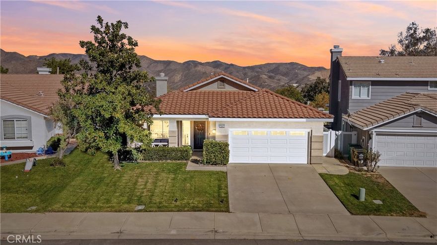 SINGLE STORY | PANORAMIC VIEWS | UPGRADED AND MOVE-IN READY | LOW HOA | LOW TAXES | Impeccably maintained by its original owner, this stunning open-concept, single-story home is located in the highly desirable Horsethief Canyon Community. From the moment you arrive, the lovely curb appeal and expansive front porch welcome you—an ideal spot to enjoy your morning coffee while taking in the sunrise. Step inside and be greeted by soaring cathedral ceilings, luxury flooring, and large picture windows that fill the home with natural light at every angle. The Living Room and formal Dining Room create the perfect space for entertaining, while the heart of the home—the Kitchen—impresses with a spacious center island featuring a sink, breakfast bar seating, walk-in pantry, and informal dining nook. Open concept living continues with the adjacent Family Room, highlighted by an upgraded marble-surround fireplace and direct access to the backyard through sliding glass doors. The Primary Ensuite Bedroom is a serene retreat with a private slider to the backyard. The Primary Ensuite Bathroom offers walk-in shower, dual sinks, upgraded flooring, a linen closet, and a generous walk-in closet. Bedroom #2 and Bedroom #3 are both well-sized and perfect for family or guests, with a full bathroom conveniently nearby. A separate laundry room provides both function and convenience for modern living. The low-maintenance backyard is a true haven—featuring panoramic views, a built-in BBQ with island, fountain, raised lounge area, mature trees, and a dedicated 220-volt pad for a spa, all surrounded by durable and maintenance free vinyl fencing. A long and wide side-yard would be perfect for a dog run or garden space! Energy efficiency features include LED lighting and multiple ceiling fans throughout. Enjoy resort-style community amenities, including two nearby pools, spa, clubhouse, gym, park with walking/running trails, and sports courts. Ideally located within walking distance to the elementary school and surrounded by scenic trails, this beautifully cared-for home blends comfort, style, and community living at its finest. Easy access to Highway 15 and the nearby 15/91 Expressway entrance make commuting to Orange County a breeze. Enjoy peaceful living in this beautiful, turnkey home that truly has it all!