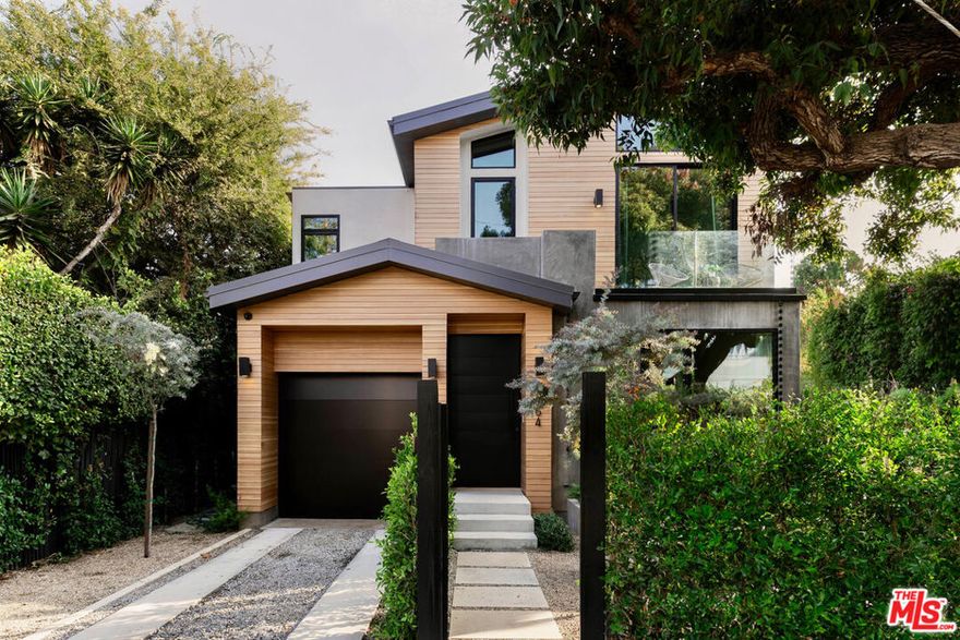 Nestled within West Hollywood's prestigious Norma Triangle, this newly built warm contemporary epitomizes the pinnacle of modern luxury. Past the gracefully hedged and gated front yard, this architectural marvel exudes tranquility and sophistication, accentuated by exquisite white oak details throughout. The open floor plan fosters an effortless flow between the inviting interior spaces and the tranquil private backyard retreat, which features a sleek, modern pool perfectly suited for both serene relaxation and refined entertaining. This distinguished residence encompasses 3 elegantly appointed bedrooms, 4 lavish bathrooms, an open office/den, and the convenience of a two-car garage. The gourmet kitchen is a chef's dream, boasting an expansive entertainer's island, custom white oak cabinetry, and top-tier Viking appliances. The primary suite serves as an idyllic sanctuary, complete with a bespoke walk-in closet, expansive windows that invite natural light, and a spa-like bathroom adorned with the breathtaking Calacatta Viola marble. With its unparalleled high-end finishes and meticulous attention to detail, 9064 Harland radiates elegance and sophistication while being conventionally located next to the city's most coveted shops and dining establishments.