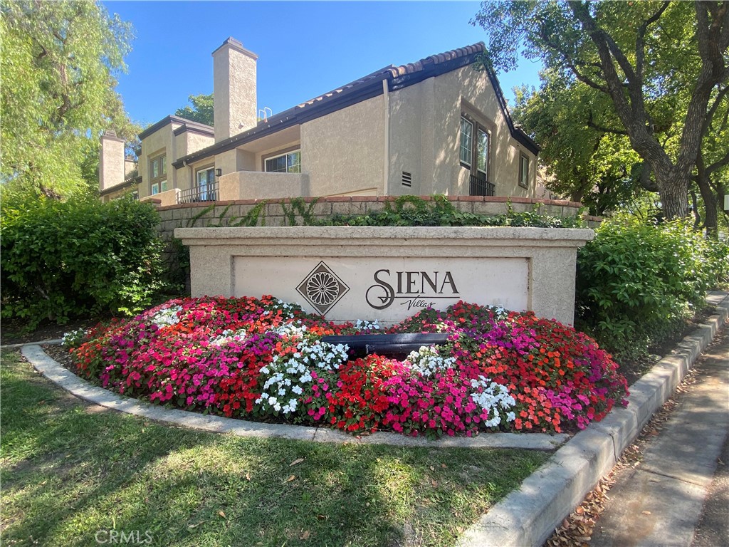 Welcome to one of the most sought-after locations in Valencia! This beautifully situated upper-level 1-bedroom + loft condo in Siena Villas offers the perfect blend of comfort, convenience, and resort-style living. Step inside to a light and airy living space with soaring ceilings and an open loft with laminate flooring and a closet, ideal for a home office, guest room, or creative space. Enjoy peace of mind with 2 gated subterranean parking spaces, a private garage storage locker, and in-unit stackable washer/dryer for added convenience. The Siena Villas community is known for its lush grounds and unbeatable amenities, including 3 sparkling pools/spas, tennis courts, a car wash station, and inclusive water & trash, all in a dog-friendly environment. This home’s prime location within the complex puts you just moments from Whole Foods, Starbucks, the Westfield Valencia Town Center, and The Summit Park across the street. Enjoy easy access to the paseos, nearby College of the Canyons, CalArts, and the 5 Freeway, making work, play, and everything in between a breeze. FHA approved. No Mello Roos. Whether you're a first-time buyer, investor, or downsizer, this is a rare opportunity to live in the heart of Valencia.