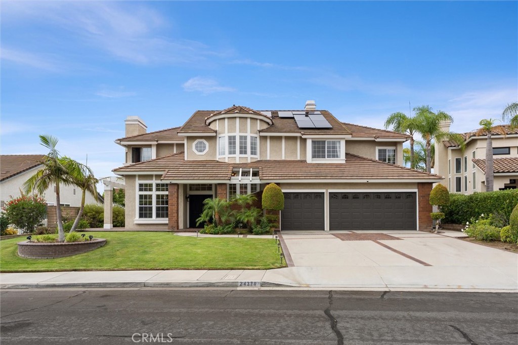 Welcome to Brighton Estates, where timeless elegance meets modern luxury. Featuring PAID OFF solar panels, a sparkling pool, spa and custom-built fire pit, TWO kitchens, a home theater, and two main floor bedrooms and bathrooms, this home is equally built for entertaining as it is for daily living.
This exceptional cul-de-sac residence offers over 4,300 square feet of thoughtfully designed living space, blending sophistication, comfort, and convenience. Step inside to discover five bedrooms and four and a half baths, including a desirable main-level suite with its own private entrance—ideal for multigenerational living or guest accommodations. The primary floor also features a secondary flex office or bedroom and convenient guest half bathroom.
Luxurious details abound: crown molding, recessed lighting, travertine flooring, dual staircases, soaring ceilings and three gas fireplaces enhance the home’s sophisticated ambiance. The formal living and dining rooms flow seamlessly into a chef’s gourmet kitchen, showcasing granite countertops, rich espresso cabinetry, a large center island, walk-in pantry, and premium stainless steel appliances, including a 5-burner stove. A secondary kitchen—complete with its own stove, refrigerator, and storage—offers versatility for entertaining or extended family use.
Upstairs, the primary suite offers a true sanctuary, featuring high ceilings, a fireplace, and a private deck overlooking the resort-inspired backyard. The spa-like en suite bath is designed with indulgence in mind—boasting a soaking tub, dual-head shower, and two expansive closets. Two additional bedrooms, each with their own en suite bath, along with a dedicated home theater and bonus room, complete the second floor.
Outdoors, the private oasis awaits. A sparkling pool and spa, built-in BBQ, custom fire pit with built-in seating, lush landscaping, and a putting green create an entertainer’s dream. Paid-off solar panels and a newer roof provide both luxury and peace of mind.
Nestled within the highly acclaimed Placentia-Yorba Linda School District and close to parks, trails, and local amenities, this rare offering combines resort-style living with everyday convenience in one of Orange County’s most coveted neighborhoods.
