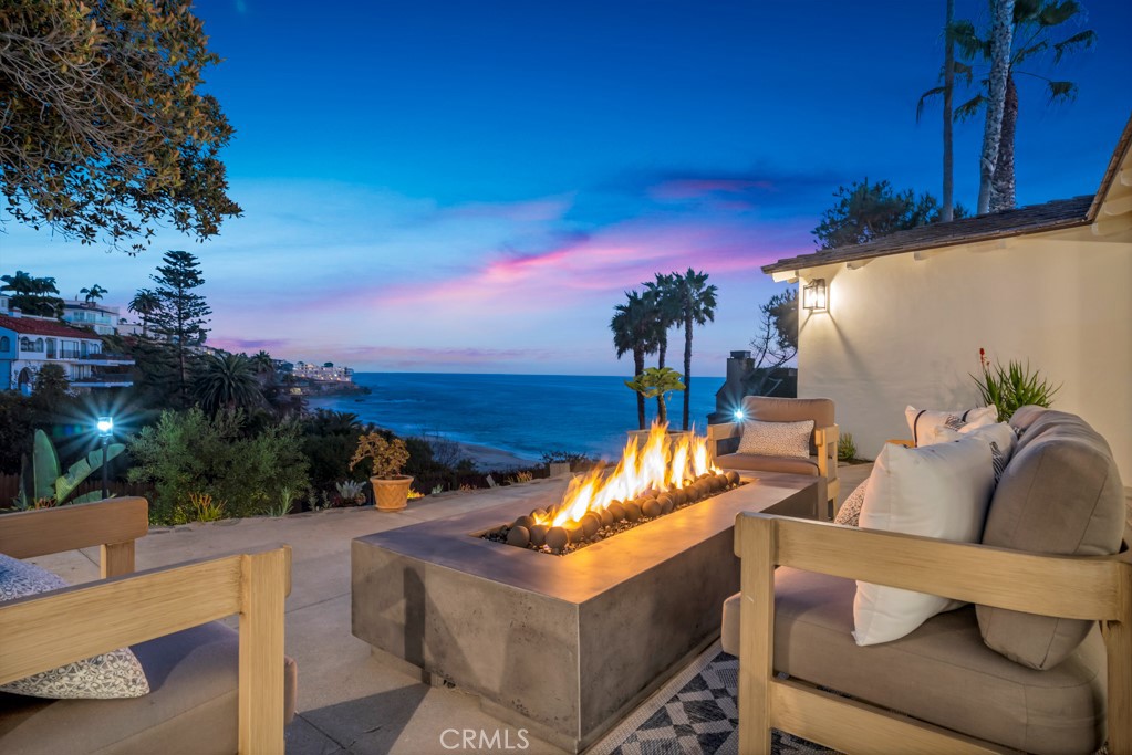 Welcome to Paradise! Enjoy quintessential beach living on one of the most coveted lots Laguna Beach has to offer! Featuring two quintessential Laguna Beach homes on a massive dreamy 11,050 SF lot with spectacular ocean views and direct beach access. Get lost in the lush newly landscaped lot featuring numerous entertainment areas with breathtaking ocean views throughout. Reimagined by renowned designer Nate Fischer, often seen on TV, to preserve the beachy authentic splendor while also modernizing the homes with the finest finishes. The first home is 1,970 SF with 3 spacious bedrooms, 2 exquisite chic bathrooms, including a floating bathtub, bidet toilets and the highest-end finishes. The entire living room opens to jaw dropping ocean views serenaded by magical ocean waves. The home is complete with a gourmet kitchen featuring new Viking Appliances, a washer dryer room, and a stunning dining room with stunning ocean views! The two-story second home is perfect to complete this enchanting property featuring 2 bedrooms, 3 baths, an office and a massive entertainment room / mancave! The upper floor boasts a spacious living room with ocean views, an adorable kitchen featuring Viking Appliances and a massive bedroom, again with ocean views! The lower level enjoys an adorable office, a bathroom and a massive entertainment room complete with a kitchenette with a built-in microwave, 36 inch fridge, plenty of storage and washer dryer hookups. The home also includes brand new garage doors, security cameras, exterior lighting, windows, & doors. Also enjoy a breathtaking brand new 36 jet Jacuzzi with ocean views! This coveted property is in a gated community with only 10 homes while not requiring any HOA fees. The street offers plenty of private parking as well. The remodel was permitted. In addition, plans to expand the first floor and add a beautiful second story to the main home and a stunning infinity pool have already been city approved! Run, don't walk to enjoy coastal living at its finest! Make sure to see the stunning video below or at 10CamelPoint.com! Must see to believe!