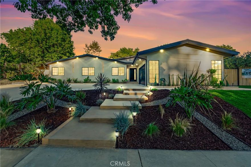 Set on a 14,165 sq. ft. flat and private lot in prime Woodland Hills, this stunning modern farmhouse offers the ultimate blend of luxury, space, and seclusion

This fully remodeled and expanded modern farmhouse sits on a spacious, private flat lot and has been reimagined from top to bottom with luxury finishes and modern upgrades. Virtually everything is new, including pool, backyard, patio, electrical, plumbing, roofing, HVAC, and more—making this home completely turnkey.

The open-concept floor plan boasts vaulted ceilings, wide-plank water proof wood floors, skylights, and expansive black-framed windows that flood the home with natural light. The chef’s kitchen features custom cabinetry, a stone waterfall island, high-end appliances, and a walk-in pantry—opening to a spacious dining area and great room, ideal for entertaining.

Retreat to the luxurious primary suite with vaulted ceilings, direct yard access, and a spa-like bath with dual vanities and a large walk-in shower. Three additional bedrooms, including a private mini suite, provide flexibility for family, guests, or office use.

Step outside to a brand-new resort-style pool and spa, surrounded by a fully private backyard with smooth stucco Venetian-plaster walls. The redesigned outdoor space includes a turf play area and a covered patio/pergola lounge with string lighting and a built-in fire pit—perfect for year-round entertaining.

Additional highlights include two brand-new HVAC systems, smart-home upgrades, a dedicated laundry room, RV parking with full hookups being installed, and a finished two-car garage equipped with electric vehicle power.

Ideally located near top schools, shopping, and dining, this property combines privacy, luxury, and convenience—offering top-notch modern living in the Valley at its finest.