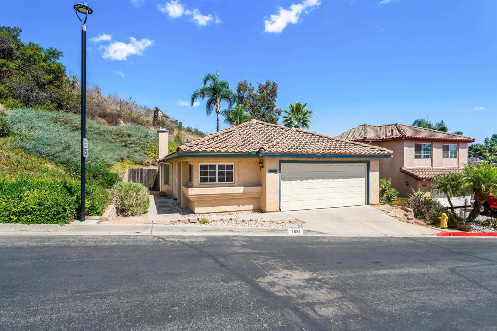 This inviting single-level corner home is nestled beside a hillside of nature and tranquility. With hills and walking trails behind you, one of North Escondido's desirable gated communities invites you to a perfect blend of comfort and serene surroundings! Entering you will be greeted by an openly flowing layout highlighted by several windows that fills the large open living room with natural light! Cozy up by the fireplace to keep warm on cold winter nights! Comes with a 2 car garage and Silverado maintains and gives you access to beautiful pool with lounging areas in a parklike setting nearby! Silverado is a small gated neighborhood easy walking to the beautiful large refreshing community pool and walking trails.